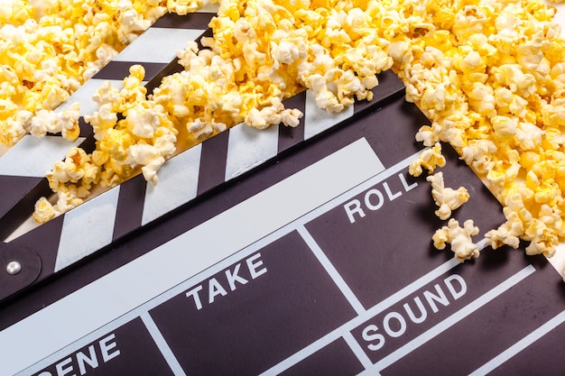 Movie clapper board and pop corn