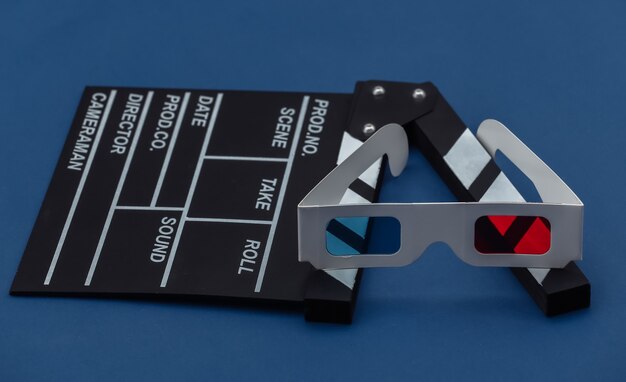 Photo movie clapper board with 3d glasses on classic blue background. cinema, movie production, entertainment industry. color 2020.