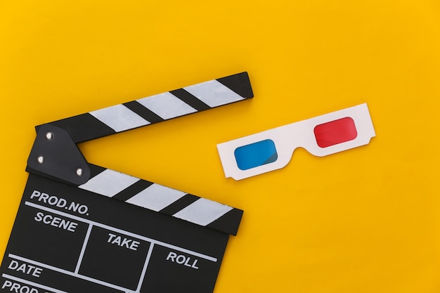 Movie clapper board with  3d glasses on yellow background. Cinema, Filmmaking, Movie production, Entertainment industry. Top view