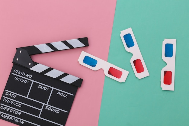 Movie clapper board with retro 3d glasses on pink blue pastel background. Cinema, Filmmaking, Movie production, Entertainment industry. Top view