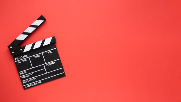 Movie clapper on red background with copy space