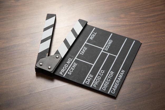 Movie clapper on the wooden background