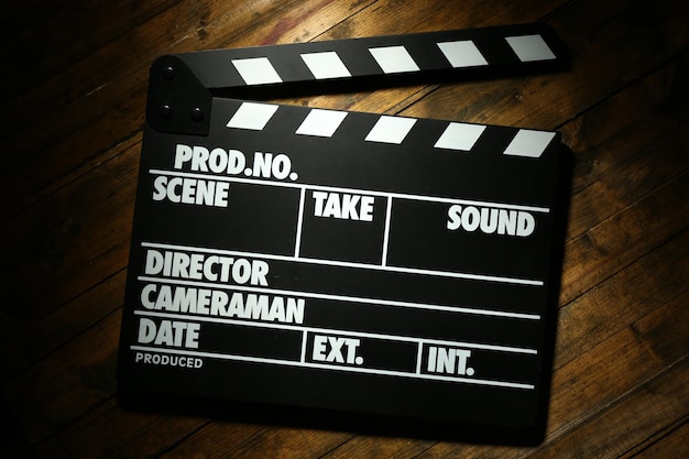 Photo movie clapper on wooden background