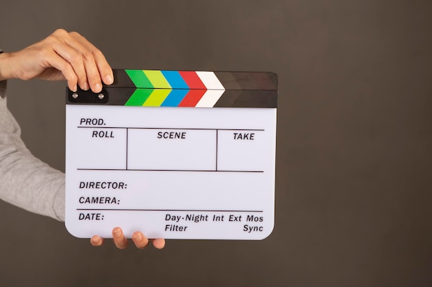 movie clapperboard held by a hand