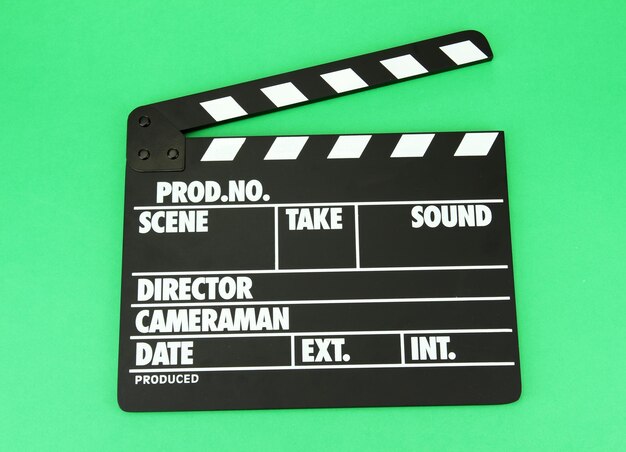 Movie production clapper board on color background