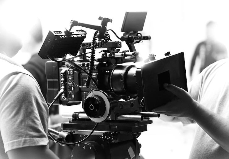 Photo movie shooting or video filming production by crew team and professional equipment such as super ultra high definition digital camera with tripod and lighting set in studio and black and white styles