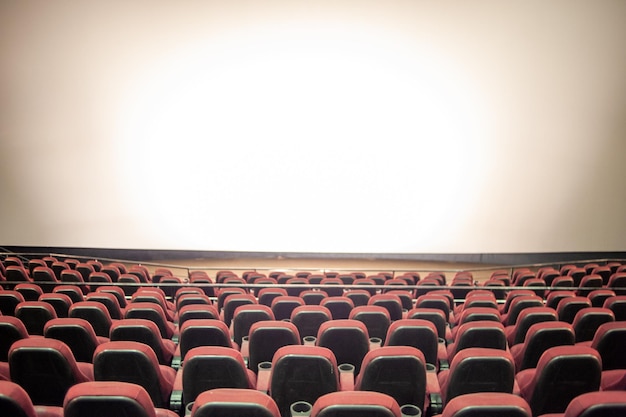 A movie theater with a large screen that says " i love you ".