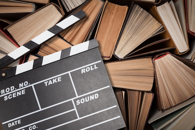 Movies adapted from books, cinema concept with clapboard and book