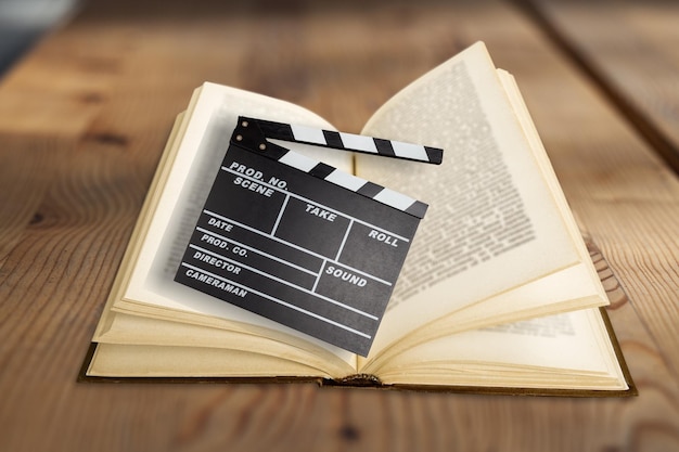 Movies adapted from books, cinema concept with clapboard and book