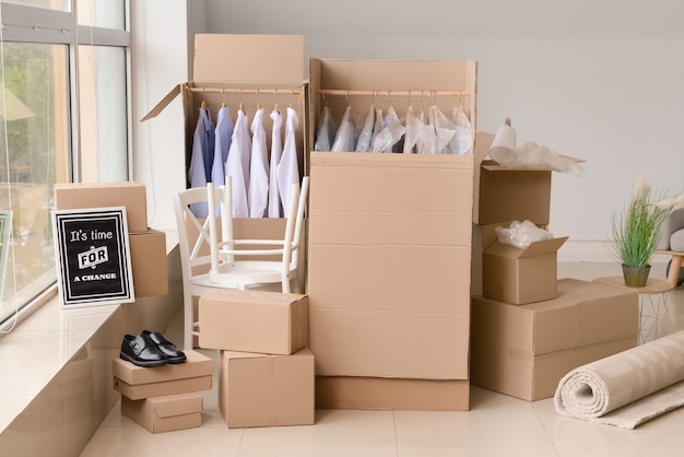 Moving boxes with belongings in room