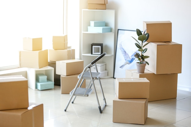 Moving boxes with belongings in room