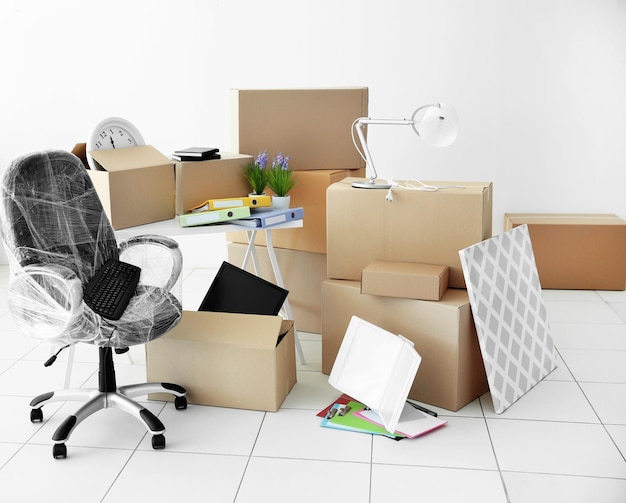 Moving cardboard boxes and personal belongings in empty office space