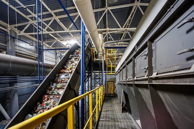 moving conveyor transporter on modern waste recycling processing plant separate and sorting garbage collection recycling and storage of waste for further disposal