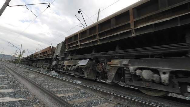 Moving of diesel locomotive and railway cars filled with ore quarry for limestone mining