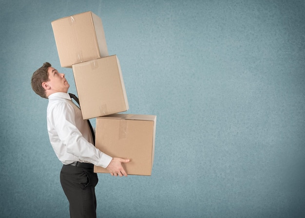 Moving. lots of cardboard boxes and man on background