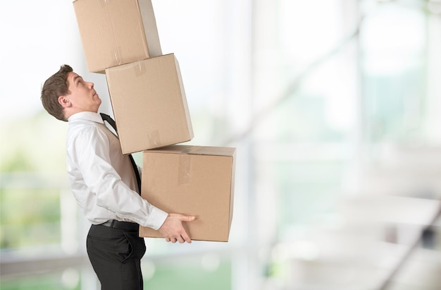 Moving. lots of cardboard boxes and man on background