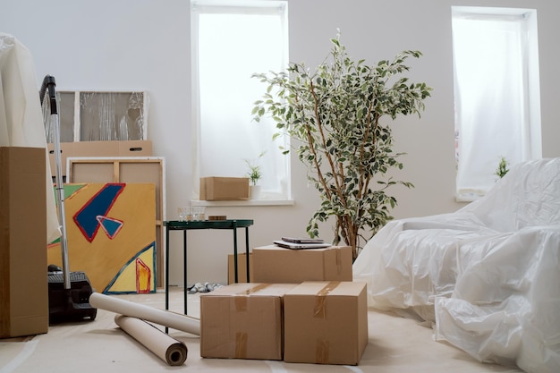 Moving in out cardboard boxes with packed things renting selling an apartment changing location