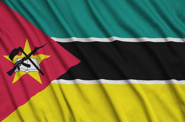 Mozambique flag is depicted on a sports cloth fabric with many folds.