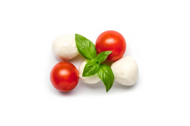 Mozzarella cheese balls cherry tomatoes and green fresh organic basil isolated on white