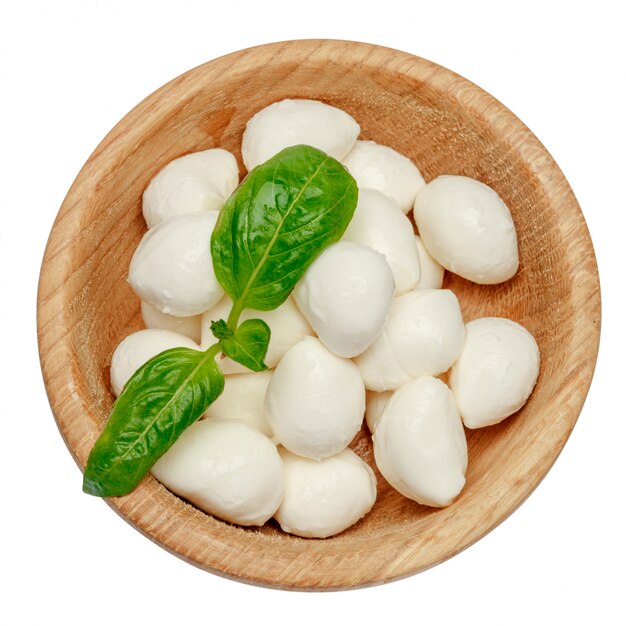 Mozzarella cheese and basil in bowl on white space