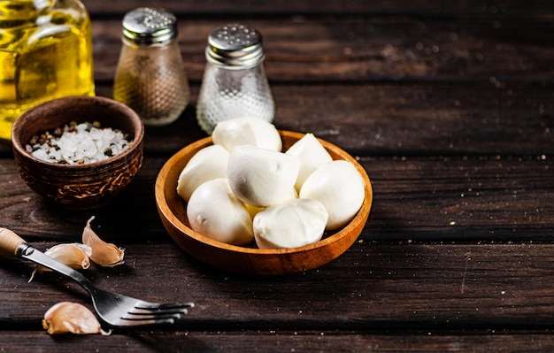 Mozzarella cheese with garlic on a wooden background