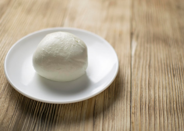 Mozzarella op een bord op een houten ondergrond