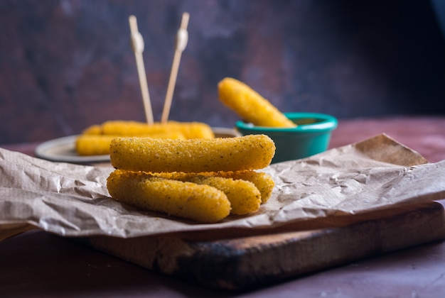 Mozzarella sticks coated with hot sauce. 