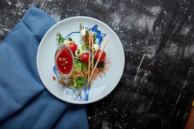 Mozzarella and tomato salad caprese on the plate