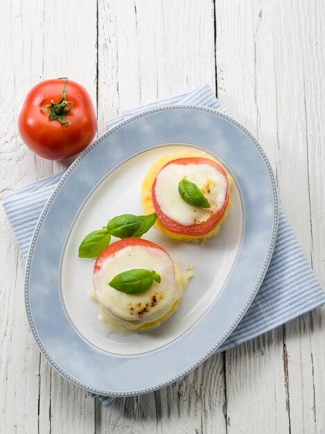 Mozzarella tomatoes and porridge vegetarian appetizer