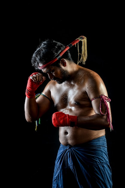 Muai thai boxer man trainings. studio shot on black