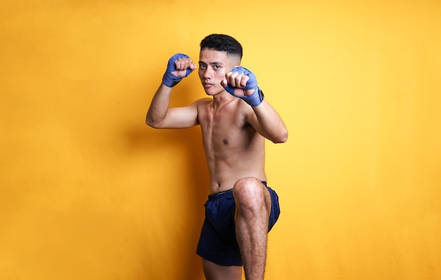 Muay Thai athlete in defense pose.