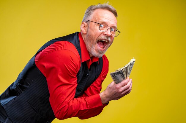 Much money in hands dollars in hands man holds dollar piles of\
dollars bills human emotions and facial expressions very excited\
man with bunch of money