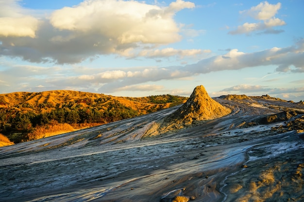 Muddy volcano round crater with mud and beautiful sunset scenery, Buzau, Romania