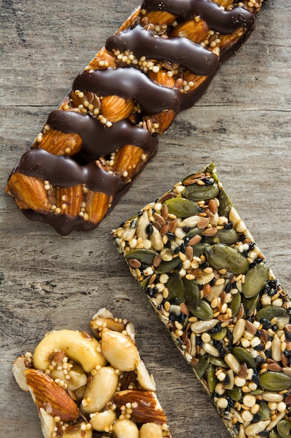 Muesli bars on wooden table, top view