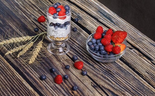 Muesli with berries and chia seeds on a wooden table 