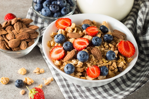 Muesli with berries and a jug of milk