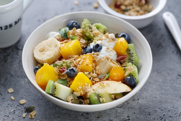 Muesli with fruits served in bowl