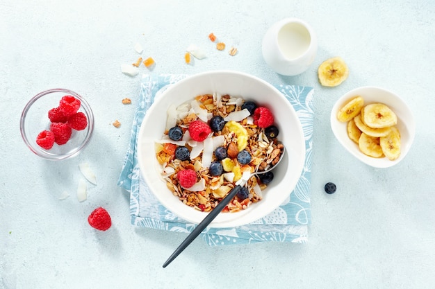 Photo muesli with milk served in bowl on white background.