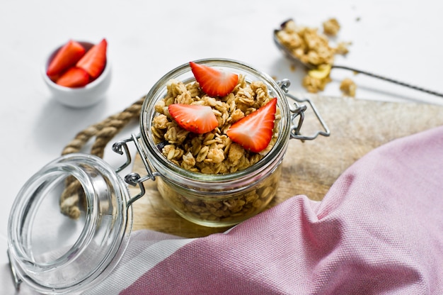 Muesli with strawberries in a glass jar. 