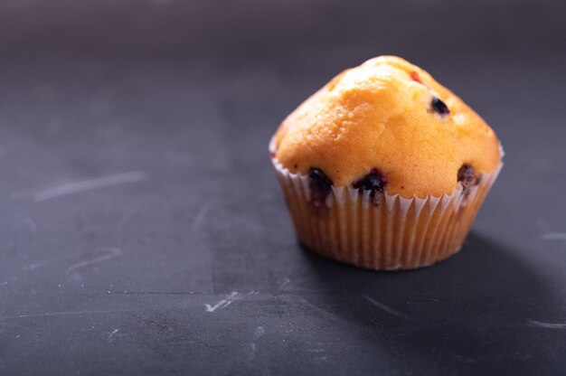 Muffin with cherries One muffin in a white box Front view