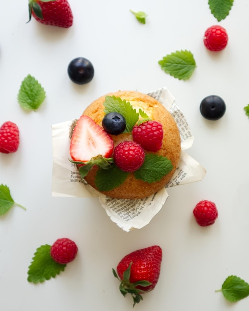 Muffin with fresh berries top view flat lay