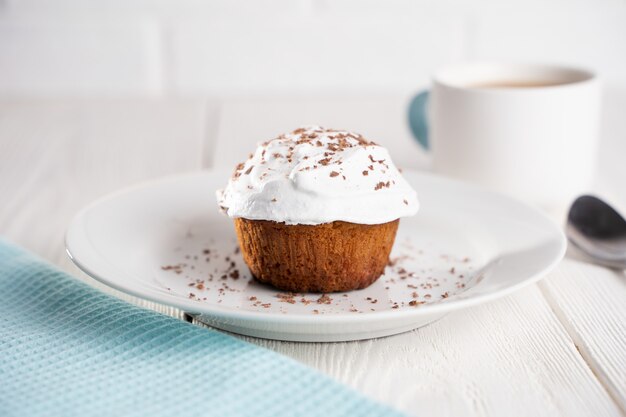 Muffin with white cream and chocolate sprinkles