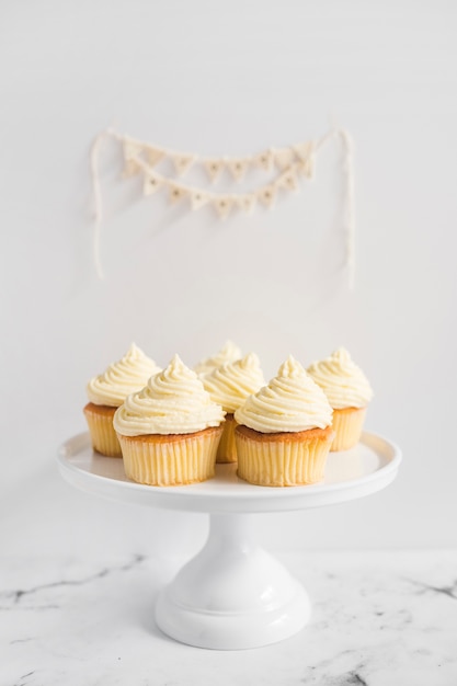 muffins on the white cake stand against white background