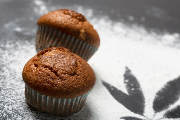 Muffins with cannabis on the table, dark background. CDB food concept, close up shot