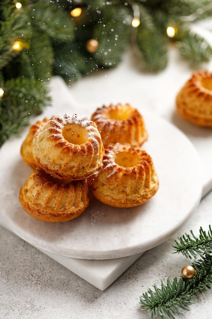 Muffins with powder or cakes on christmas in wooden box and with christmas tree Christmas sweets