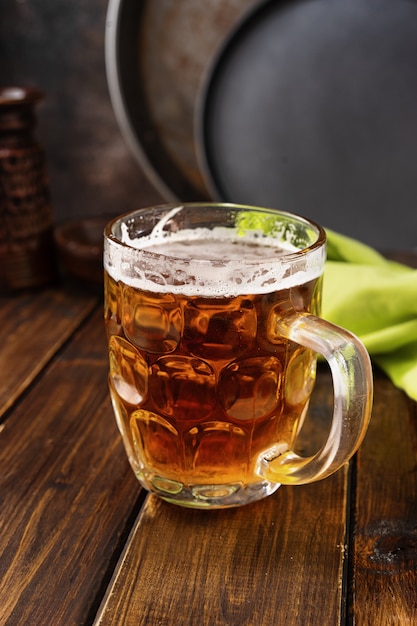 Mug of beer on dark rustic background