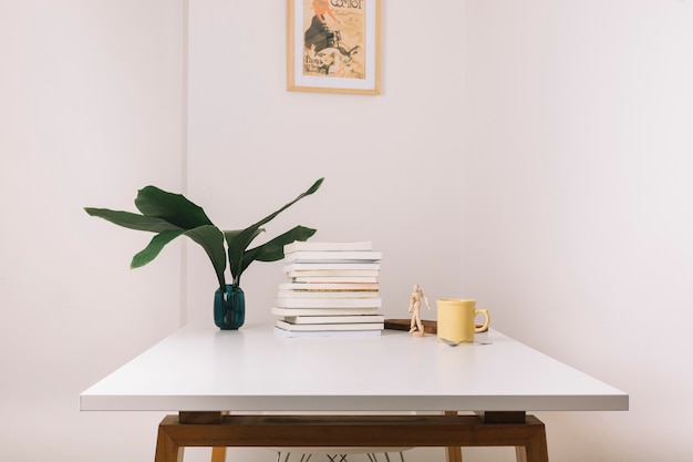 Photo mug and books on table near decorations