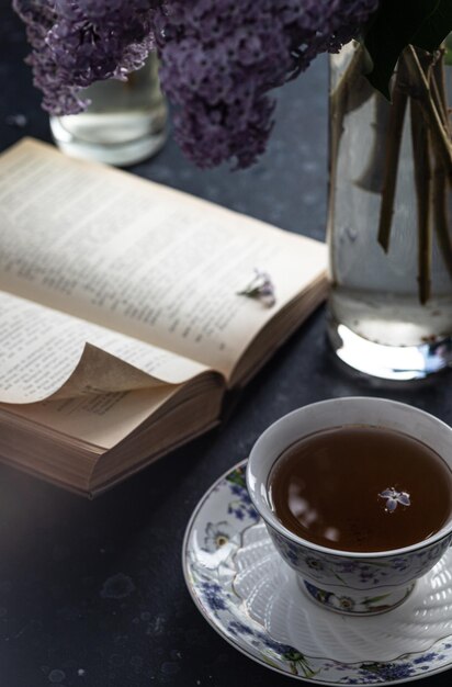 A mug and a bouquet of lilacs