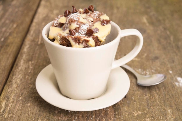 Photo mug cake with chocolate close up