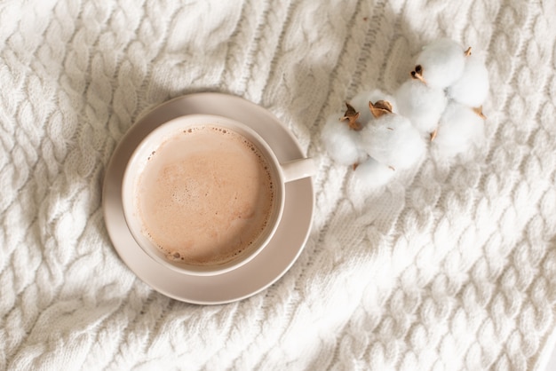 mug of cocoa on a knitted background background.